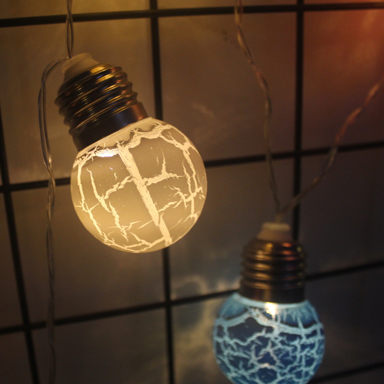 Cracked bulb LED string lights with warm and cool glow for festive decoration