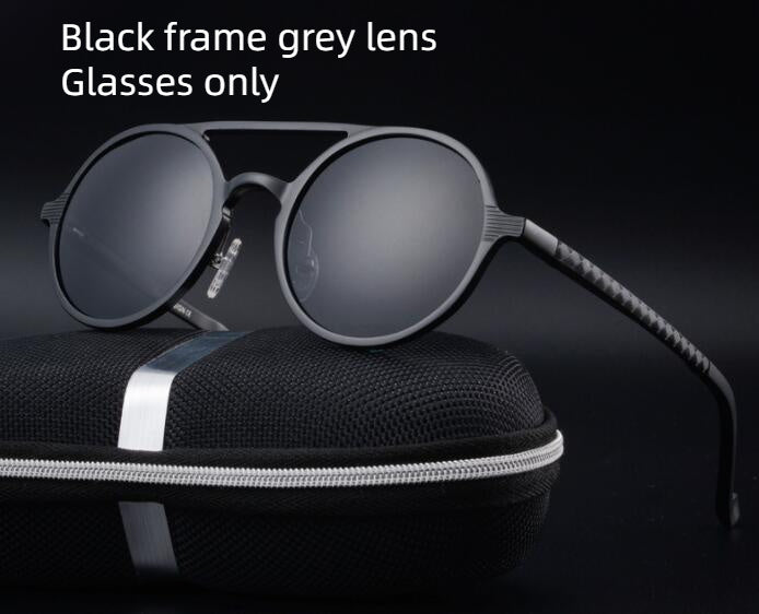 Retro aluminum magnesium sunglasses with black frame and grey lenses on a carrying case.