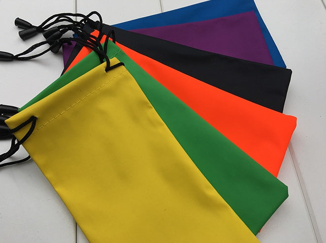 Colorful drawstring bags for eyewear with lanyards on a white surface.