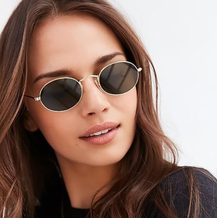 Fashion women sunglasses with oval metal frames and UV400 protection.