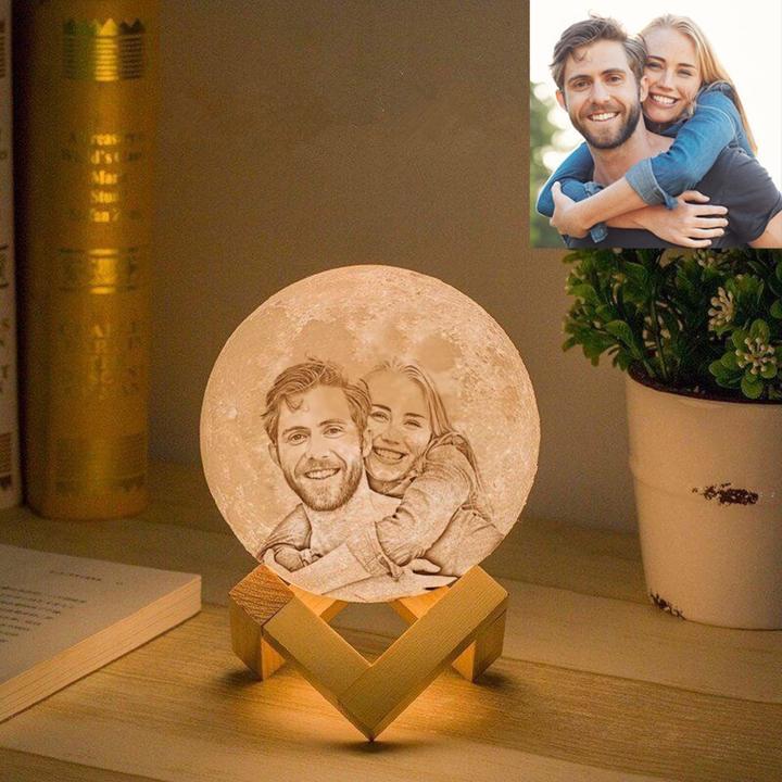 Custom moon lamp with personalized photo and dual color LED lights on wooden base.