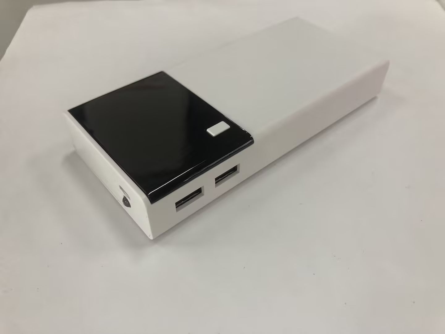 20000mAh black and white power bank with dual USB ports.