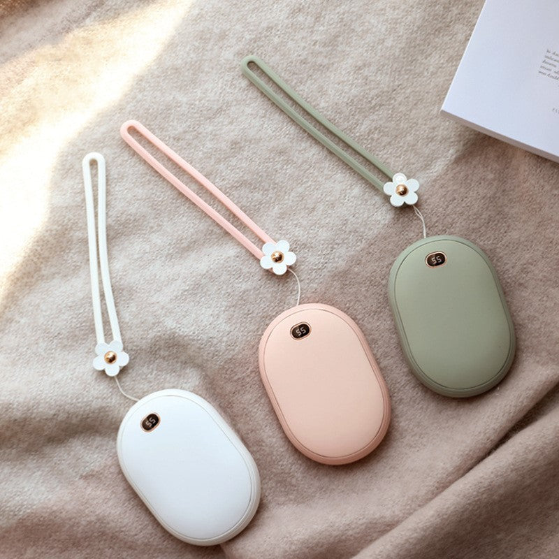 Mini power bank in three colors with floral straps on soft fabric background.