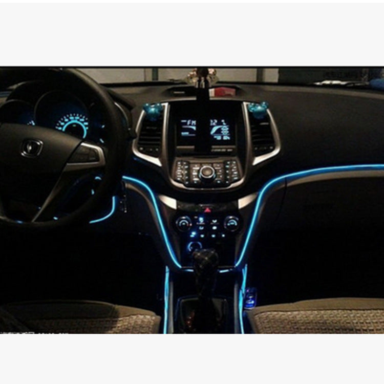 Car interior with blue LED strip light highlighting dashboard and console areas.