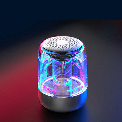 Portable Bluetooth speaker with powerful bass and variable color LED light, ideal for outdoor use.