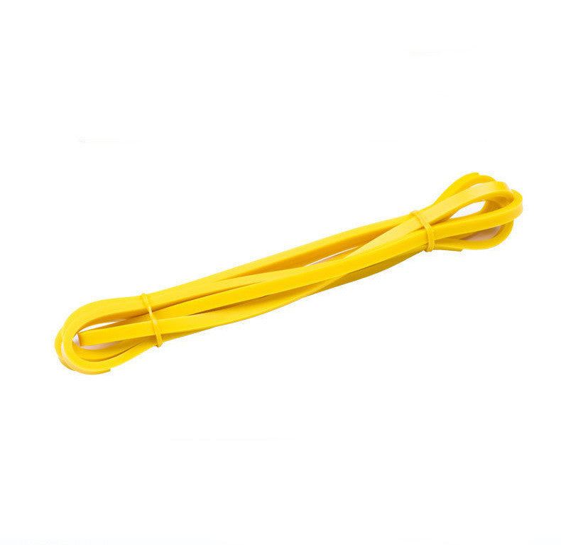 Yellow latex resistance band for fitness and strength training.