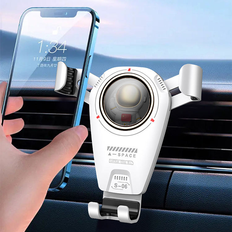 Universal car phone holder with 360-degree rotation and astronaut theme, mounted on a car air vent.